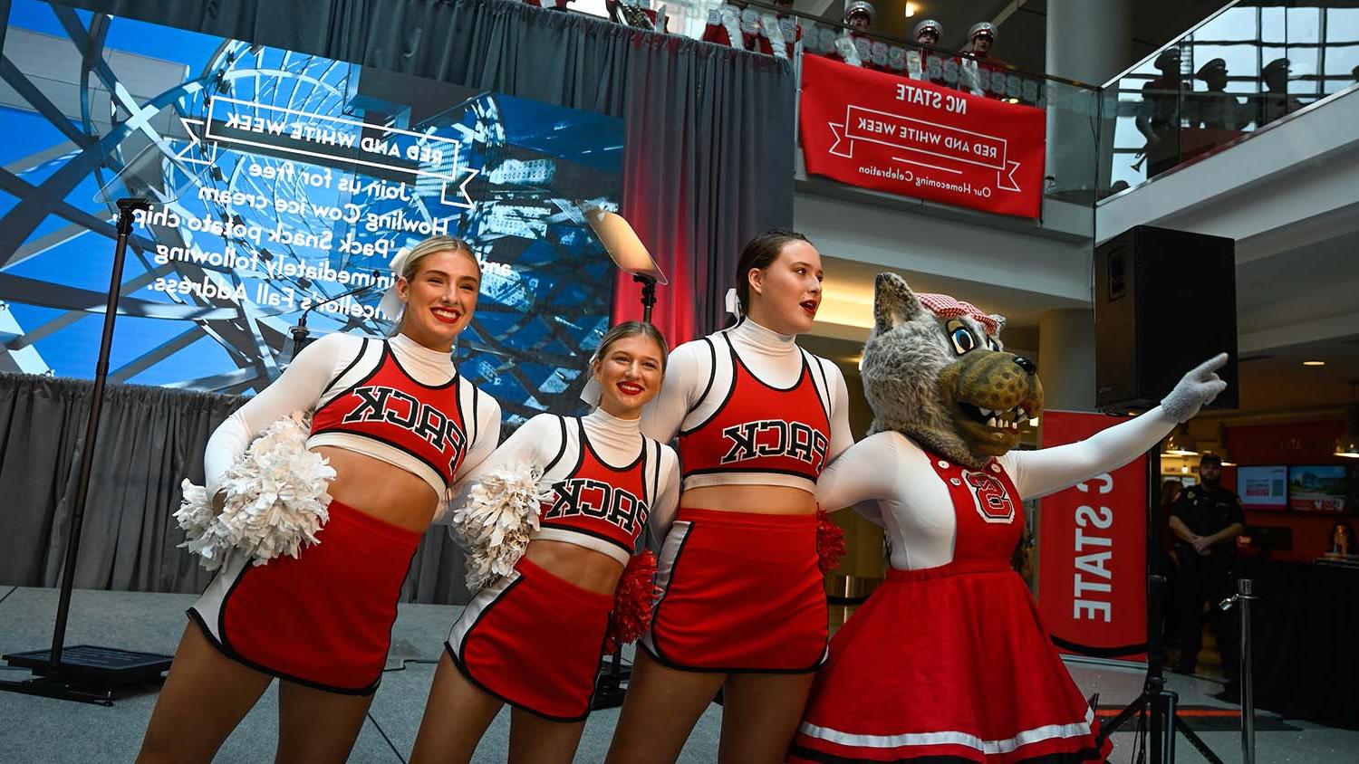 Ms. Wuf and NC State cheerleaders enjoy the 总理's remarks at the annual Fall Address at the Talley Student Union.